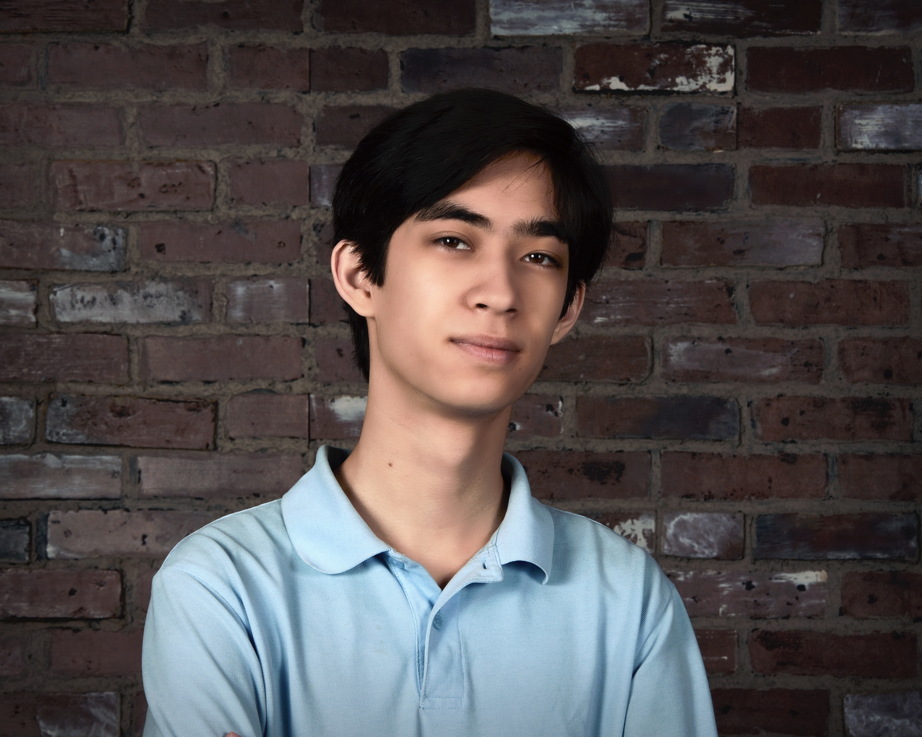 Picture of Christopher, with a brick wall background